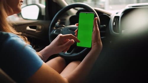 Female Driver Using a Smartphone Inside the Car