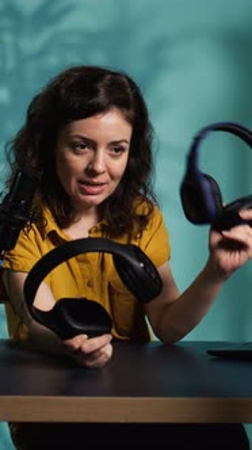 Woman Reviewing Headphones While Sitting at Desk