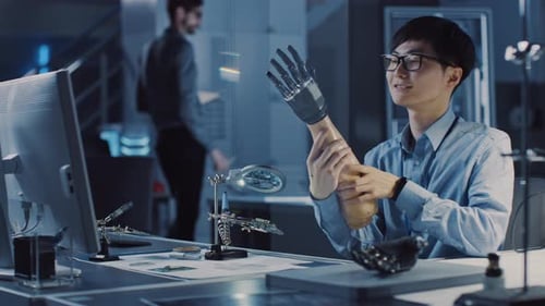 Futuristic Prosthetic Robot Arm Being Tested by a Professional Japanese Development Engineer in a H
