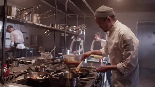 Chef Cooking Food in Commercial Kitchen