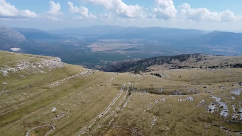 awesome drone shot of a green meadow in the dinara area of croatia, sunny weather