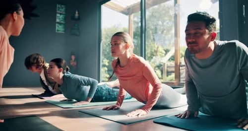 Yoga Class Practicing Upward-Facing Dog Pose