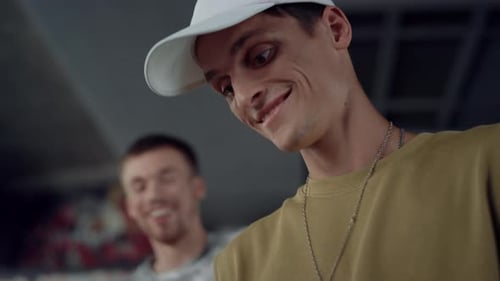 Excited teenage friends laughing at funny video on smartphone at skate park