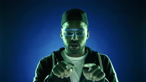 Man Uses Futuristic Glasses on Blue Backdrop