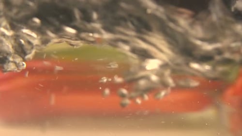 Boiling water with uncooked pasta, carrots, lettuce