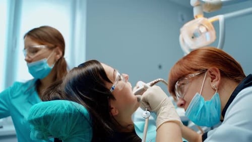 Dentist Performing Dental Procedure on Female Patient