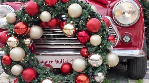 Red Car Decorated with Christmas Wreath and Bow