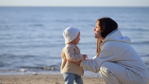 Mother and Child Embrace on a Sunny Beach