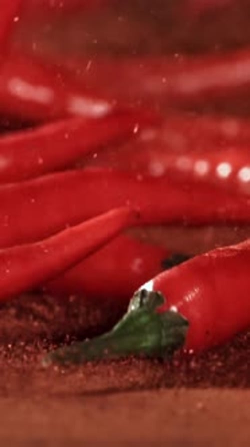 Red Chili Pepper in Flight with Ground Pepper Filmed on a Highspeed Camera at 1000 Fps