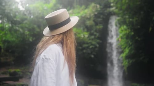 Carefree Blonde Woman in Straw Hat Admire View Mountain Waterfall in Wild Nature Girl Tourist in