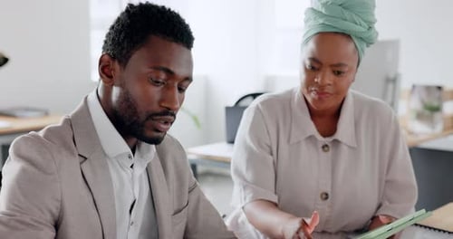 Office Workers Reviewing Business Documents on Tablet