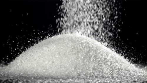Sugar Falls on the Table in a Heap Filmed on a Highspeed Camera at 1000 Fps