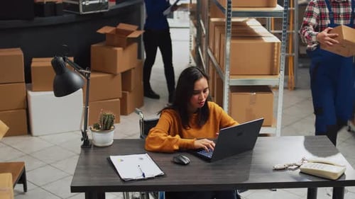 Young Employee with Impairment Working in Warehouse