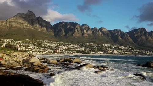 BREATHTAKING CINEMATIC FORWARD LOW FLYING SHOT OF BEAUTIFUL CAPE TOWN´S CAMPS BAY BEACH WITH TABLE M