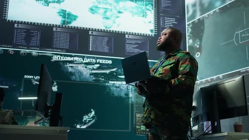 Men Monitor Integrated Data Feeds in Control Center