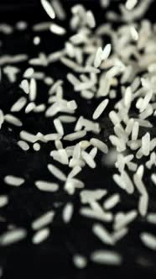 A Pile of Uncooked Rice Falls on the Table Filmed is Slow Motion 1000 Fps