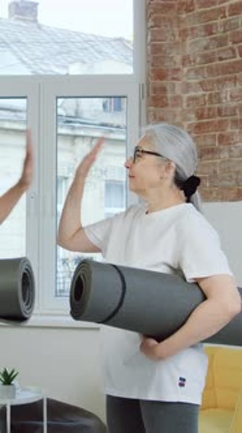Senior Couple Holding Yoga Mats, Ready for Exercise