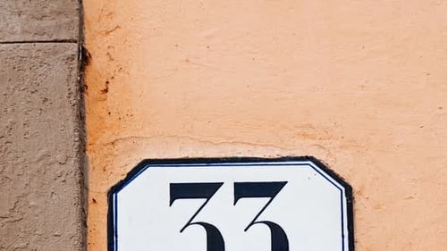 Number 33 (thirty-three) Affixed to a Building