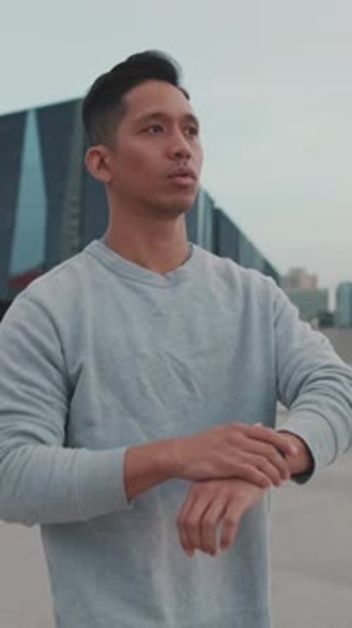 Man Checks Watch and Starts Running Outside