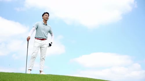 Golfer Male Golf Sport Athlete Holding a Golf Club Gazing into the Distance Walking on a field playi