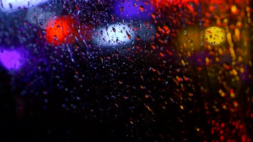 Abstract Blur Background of Rainy City at Night. Pov From the Moving