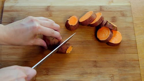 Slicing Sweet Potato on Cutting Board
