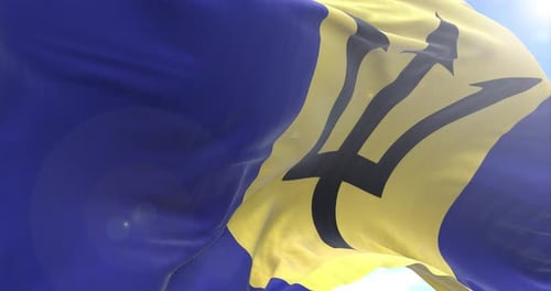 Waving Barbados Flag Against Blue Sky