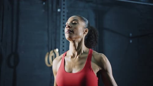 young woman training and working out in a industrial styled old gym.