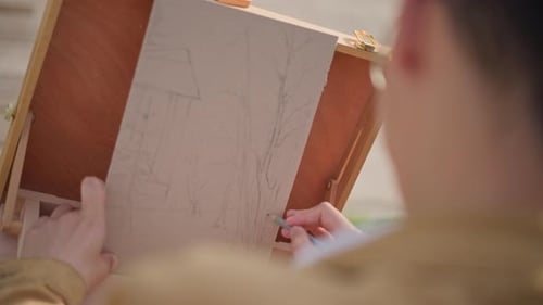 Artist Sketching Landscape Drawing Outdoors in Sunny Day