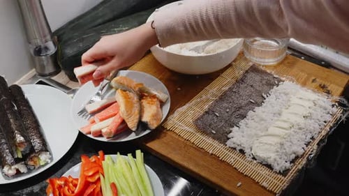 Preparing Sushi Rolls with Salmon and Vegetables