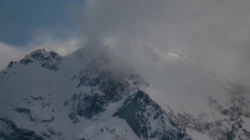 4K Timelapse of clouds moving through the snowy Rocky Mountains
