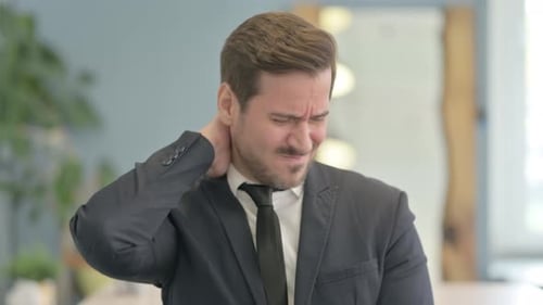 Man in Suit Rubbing Aching Neck