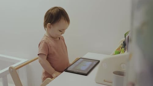 Toddler Using Tablet Device at Home