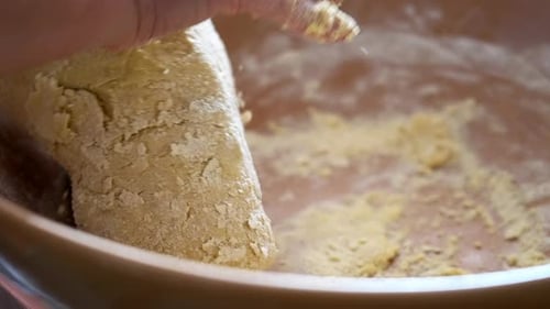 Adult Hands Kneading Dough in a Bowl