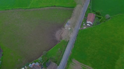 Static view from above of a long street in a countryside. Daylight