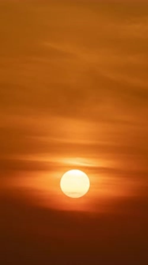 Sun Rising into Vivid Orange Sky