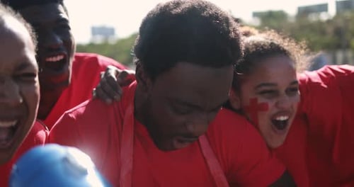 Enthusiastic Group Cheering Together Outdoors in Daytime