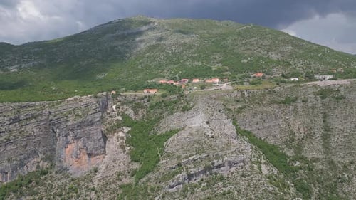European village against the backdrop of a beautiful mountain panorama. Aerial view.