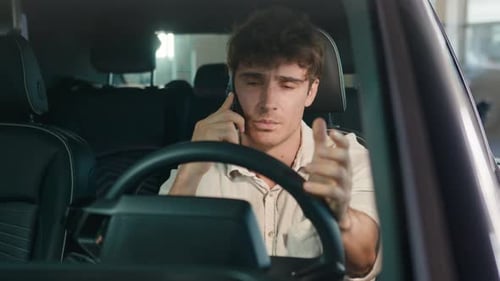 Young Adult Talking on Smartphone in Car