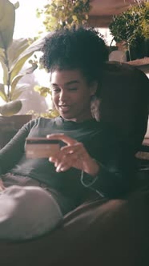Woman Relaxing On Couch Using Her Phone