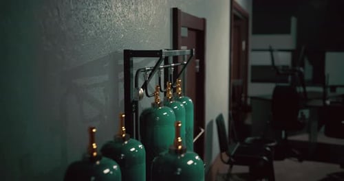 Industrial Space with Green Gas Cylinders on a Textured Wall