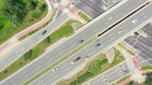 Aerial view of a freeway intersection. Clip. Highway and overpass with cars and trucks, interchange,
