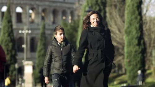 Mother and child walking near the Colosseum in Rome