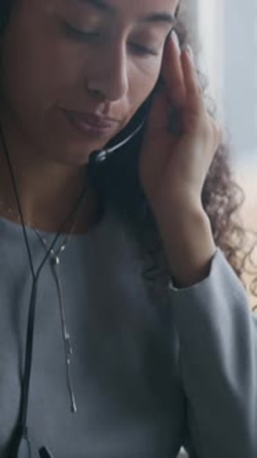 Confident Operator with Headset Speaking to Customer and Taking Notes