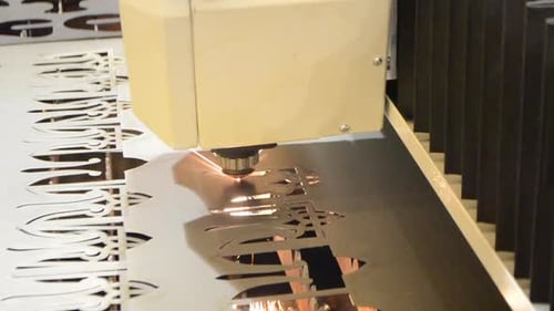 Laser Cutting Machine Creating Intricate Metal Pattern