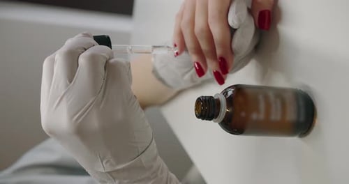 The manicure master applies oil to the cuticle to the client, massages hands,
