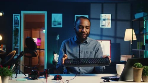 Man Reviews Computer Accessories at Desk