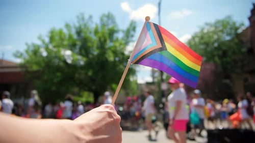 Pride Flag Waving in a Crowd at Pride Parade