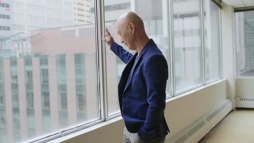 Man Walking to Window in Empty Office Adult