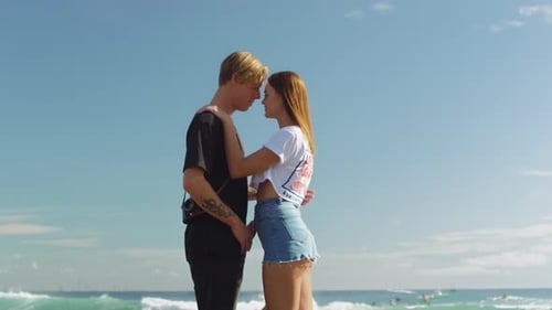 Affectionate Couple Embrace on Sunny Tropical Beach